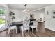 Bright dining room featuring hardwood floors, a modern chandelier, and a large window overlooking the yard at 529 Greystone Trl, Marietta, GA 30068