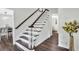 Inviting entryway showcasing hardwood floors and a staircase with decorative lighting at 529 Greystone Trl, Marietta, GA 30068