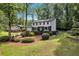 Charming two-story home featuring black and white siding with a well-manicured lawn and beautiful landscaping at 529 Greystone Trl, Marietta, GA 30068