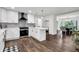 Open kitchen with white cabinets, stainless steel appliances, subway tile backsplash, and a cozy dining area at 529 Greystone Trl, Marietta, GA 30068