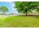 Picturesque backyard featuring a gentle slope, lush greenery, and a charming white picket fence at 855 Madison Chase Way, Lawrenceville, GA 30045