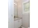Powder room features a granite-topped vanity, modern fixtures, and a window providing natural light at 855 Madison Chase Way, Lawrenceville, GA 30045
