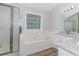Bathroom featuring a shower, a garden tub by the window, and granite countertops at 855 Madison Chase Way, Lawrenceville, GA 30045