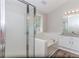 Main bathroom featuring a separate shower, large soaking tub, and double vanity with granite countertops at 855 Madison Chase Way, Lawrenceville, GA 30045