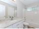 Bathroom with granite counters, tile floor, and tub with shower at 855 Madison Chase Way, Lawrenceville, GA 30045