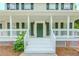 Close-up of the home's inviting front porch with white railing and a classic green front door at 855 Madison Chase Way, Lawrenceville, GA 30045