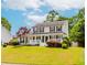 Inviting two-story home with a well-manicured lawn, front porch, and classic shutters. Beautiful curb appeal at 855 Madison Chase Way, Lawrenceville, GA 30045