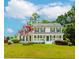 Charming two-story home with a beautifully landscaped yard, front porch, and classic green shutters at 855 Madison Chase Way, Lawrenceville, GA 30045