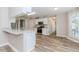 Well-lit kitchen with white cabinets, modern appliances, and wood-look flooring at 855 Madison Chase Way, Lawrenceville, GA 30045