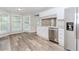 Eat-in kitchen boasts stainless appliances, granite countertops, and wood-look flooring at 855 Madison Chase Way, Lawrenceville, GA 30045