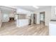Bright kitchen features stainless appliances, white cabinets, and granite countertops open to a living area with a fireplace at 855 Madison Chase Way, Lawrenceville, GA 30045