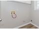 Laundry room with modern gray paint and neutral-toned flooring at 855 Madison Chase Way, Lawrenceville, GA 30045