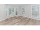 Corner view showcasing living room area with lots of natural light and wood flooring at 855 Madison Chase Way, Lawrenceville, GA 30045