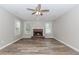 Cozy living room features brick fireplace, neutral walls, and wood-look flooring at 855 Madison Chase Way, Lawrenceville, GA 30045