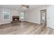 Bright living room offers brick fireplace, wood-look flooring, and a view to the hallway at 855 Madison Chase Way, Lawrenceville, GA 30045