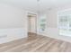 Bright living room features wood-look flooring, classic wainscoting, and updated lighting fixtures at 855 Madison Chase Way, Lawrenceville, GA 30045