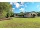 View of backyard with large grassy area, garden, and mature trees at 175 Brookhaven Dr, Marietta, GA 30066