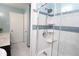 This is a full bathroom that features white tile walls and a glass door shower at 175 Brookhaven Dr, Marietta, GA 30066
