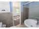 This bathroom features a single sink, tiling, a glass-door shower, and a view into the adjacent bedroom at 175 Brookhaven Dr, Marietta, GA 30066