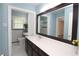 This bathroom features a single sink vanity, a large mirror, and a shower with a glass door at 175 Brookhaven Dr, Marietta, GA 30066
