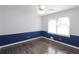 This bedroom features hardwood flooring, neutral paint, a ceiling fan, and a window at 175 Brookhaven Dr, Marietta, GA 30066