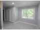 Bright bedroom featuring gray walls, tile floors, a window with blinds, and a closet with white, slatted doors at 175 Brookhaven Dr, Marietta, GA 30066