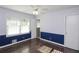 This bedroom has two windows, hardwood flooring, a ceiling fan, and a door to a bathroom at 175 Brookhaven Dr, Marietta, GA 30066