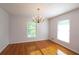 Charming dining area showcasing hardwood floors, a classic chandelier, and natural light from surrounding windows at 175 Brookhaven Dr, Marietta, GA 30066