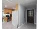 View of the entryway, showcasing a wood-cabinet kitchen and a brown front door with square windows at 175 Brookhaven Dr, Marietta, GA 30066