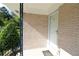 A white front door, brick facade, and landscaped garden of a charming home at 175 Brookhaven Dr, Marietta, GA 30066