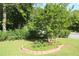 Landscaped front yard with a charming flower bed and lush green lawn at 175 Brookhaven Dr, Marietta, GA 30066
