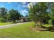 Landscaped front yard with well-maintained lawn, trees, and a long driveway at 175 Brookhaven Dr, Marietta, GA 30066