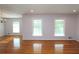 Sunlit living room with hardwood floors and large windows, complemented by a stylish chandelier at 175 Brookhaven Dr, Marietta, GA 30066