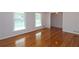 Bright living room featuring hardwood floors, neutral walls, and plenty of natural light through large windows at 175 Brookhaven Dr, Marietta, GA 30066