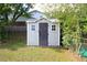 Backyard shed with neutral colored siding and a dark door at 175 Brookhaven Dr, Marietta, GA 30066