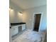 Bathroom vanity featuring marble-look floor and countertops, sleek hardware, and decorative lighting at 222 Silvercrest Dr, Acworth, GA 30101