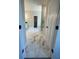 Marble-look tile, glass shower, commode and marble-look tile leading into ensuite bathroom at 222 Silvercrest Dr, Acworth, GA 30101