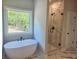 Bathroom with a freestanding tub and a glass shower with marble tile at 222 Silvercrest Dr, Acworth, GA 30101