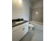 This bathroom features a modern vanity with a dark countertop, a toilet, and a tiled shower at 222 Silvercrest Dr, Acworth, GA 30101