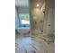 This bathroom has a stand alone shower and tub, as well as marble tile flooring at 222 Silvercrest Dr, Acworth, GA 30101