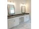 Modern bathroom featuring double sinks, white cabinets, and stylish marble flooring at 222 Silvercrest Dr, Acworth, GA 30101