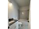 Bathroom with white vanity and toilet, and a shower with gray tile at 222 Silvercrest Dr, Acworth, GA 30101