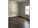 Simple bedroom with hardwood floors and a window letting in natural light at 222 Silvercrest Dr, Acworth, GA 30101