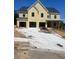 Newly constructed home features a three-car garage and covered front porch at 222 Silvercrest Dr, Acworth, GA 30101