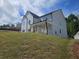 Two-story home with white siding, a porch, and green lawn on a small hill at 222 Silvercrest Dr, Acworth, GA 30101