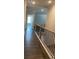 Upstairs hallway with wood floors and iron railing at 222 Silvercrest Dr, Acworth, GA 30101