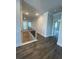 Hallway with wood floor and a staircase with a black metal railing at 222 Silvercrest Dr, Acworth, GA 30101