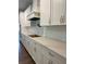 Modern kitchen boasts white cabinets, quartz countertops, and stainless steel appliances at 222 Silvercrest Dr, Acworth, GA 30101