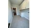 The laundry room offers abundant cabinet space, sleek countertops, and tiled floors for easy maintenance at 222 Silvercrest Dr, Acworth, GA 30101