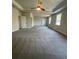 Large main bedroom showing plush carpet, tray ceilings, and access to an ensuite bathroom at 222 Silvercrest Dr, Acworth, GA 30101